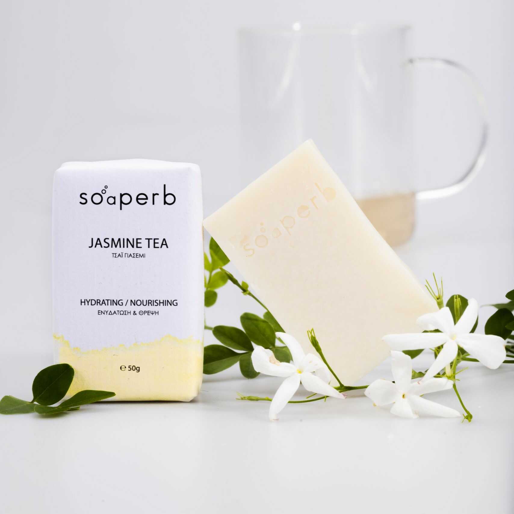 Soaperb Jasmine Tea natural soap bar with packaging, surrounded by jasmine flowers and green leaves, ideal for dry and sensitive skin – 50g.